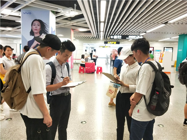 4学生在站厅内与受访者进行交流.jpg